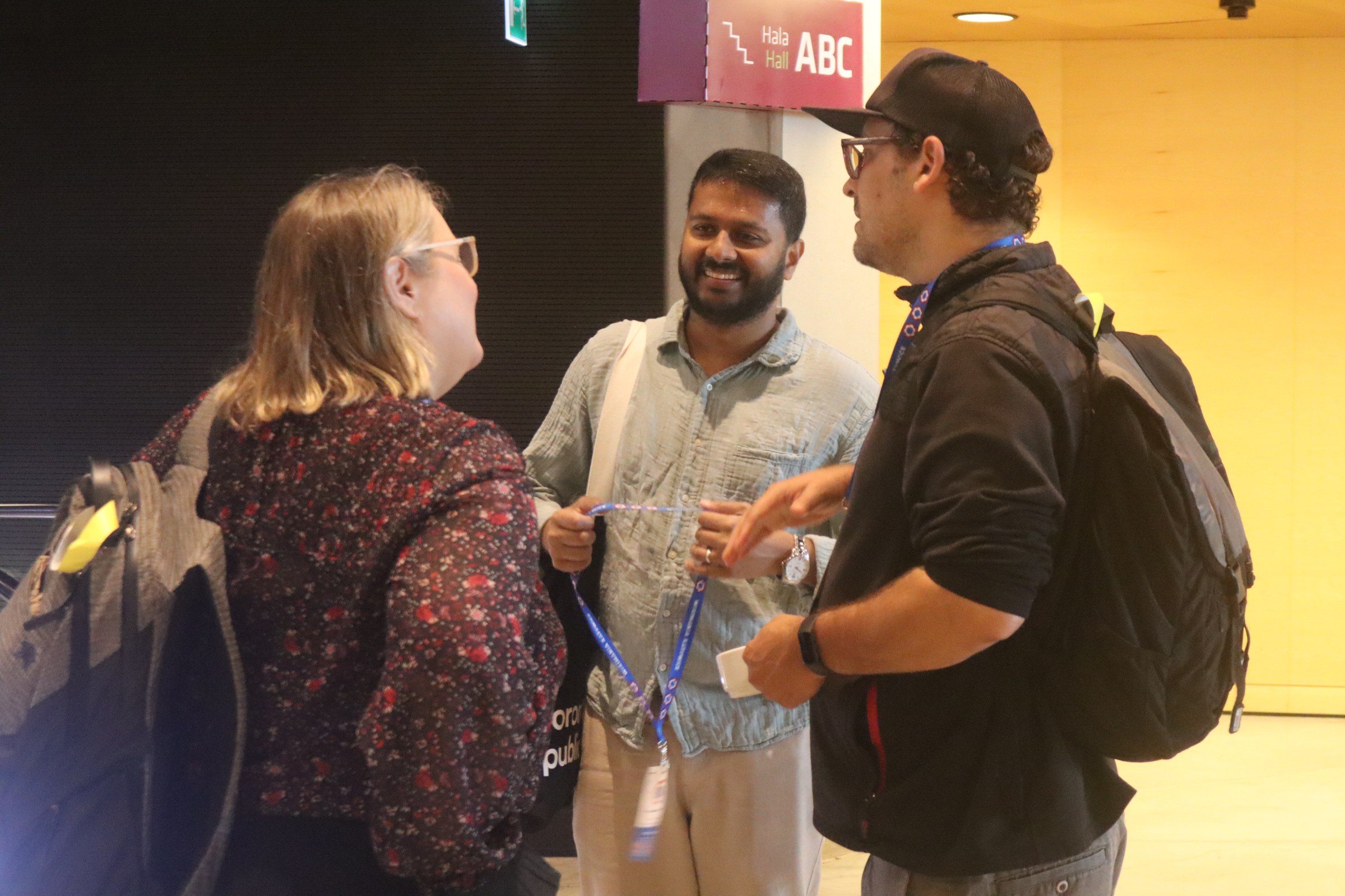 Conference participants in conversation at a 2024 congress venue